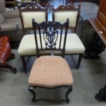 A pair of Victorian walnut chairs and an ebonised nursing chair