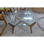 A teak and glass topped circular coffee table