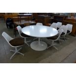 An Arkana tulip shaped table and eight 115 model chairs,