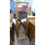 A pine cheval mirror and a towel rail