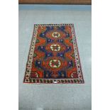 A Kurdish red ground rug - 101cm x 156cm