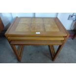A teak and tiled topped nest of tables