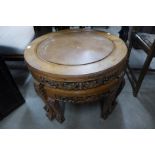 An oriental carved hardwood circular nest of tables