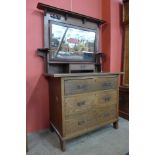 An Arts and Crafts oak dressing chest by Harris Lebus