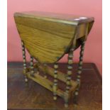 A miniature oak gateleg table