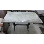 A cast iron and marble topped pub table