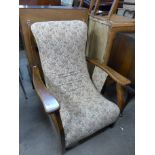 A 1930's mahogany and upholstered reclining armchair