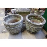 A pair of concrete garden urns