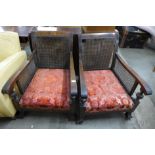 A pair of walnut bergere armchairs