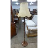 A teak standard lamp