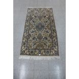 A Persian cream ground rug - 91cm x 170cm