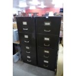 A pair of green metal filing cabinets