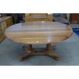 A solid walnut pedestal dining table by J.D. & M.