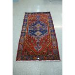 A Persian Jozan red ground rug - 114cm x 196cm