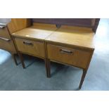 A pair of teak bedside tables