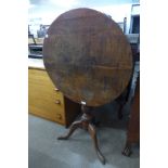 A George III oak circular tilt top tripod table