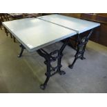 A pair of cast iron based pub tables