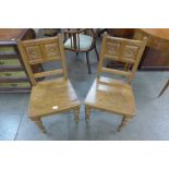 A pair of Victorian Aesthetic Movement oak hall chairs