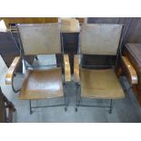 A pair of Spanish wrought iron and leather folding chairs