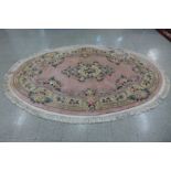 A Chinese pink ground circular rug