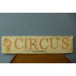 A painted wooden circus sign