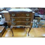 A walnut concave chest of drawers