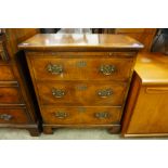 A small inlaid walnut chest of drawers