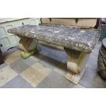 A concrete garden bench