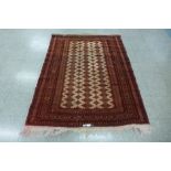A Turkman red ground rug - 136cm x 173cm