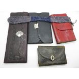 Four leather cases, one with a collection of long needles, case a/f, and one with scissors,