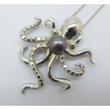 A silver octopus pendant and chain