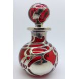 A ruby glass silver mounted perfume bottle, marked 999/1000 FINE, chip to the stopper,