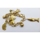 A 14ct gold charm bracelet with 9ct gold and 14ct gold charms, 30.