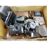 A collection of cameras including Kodak folding, a cine camera,