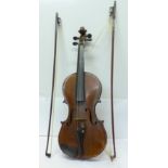 A cased violin and two bows,
