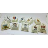 A collection of crested china cheese dishes,