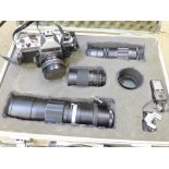 A Chinon CX 35mm camera with three lenses comprising Soligor 350mm,