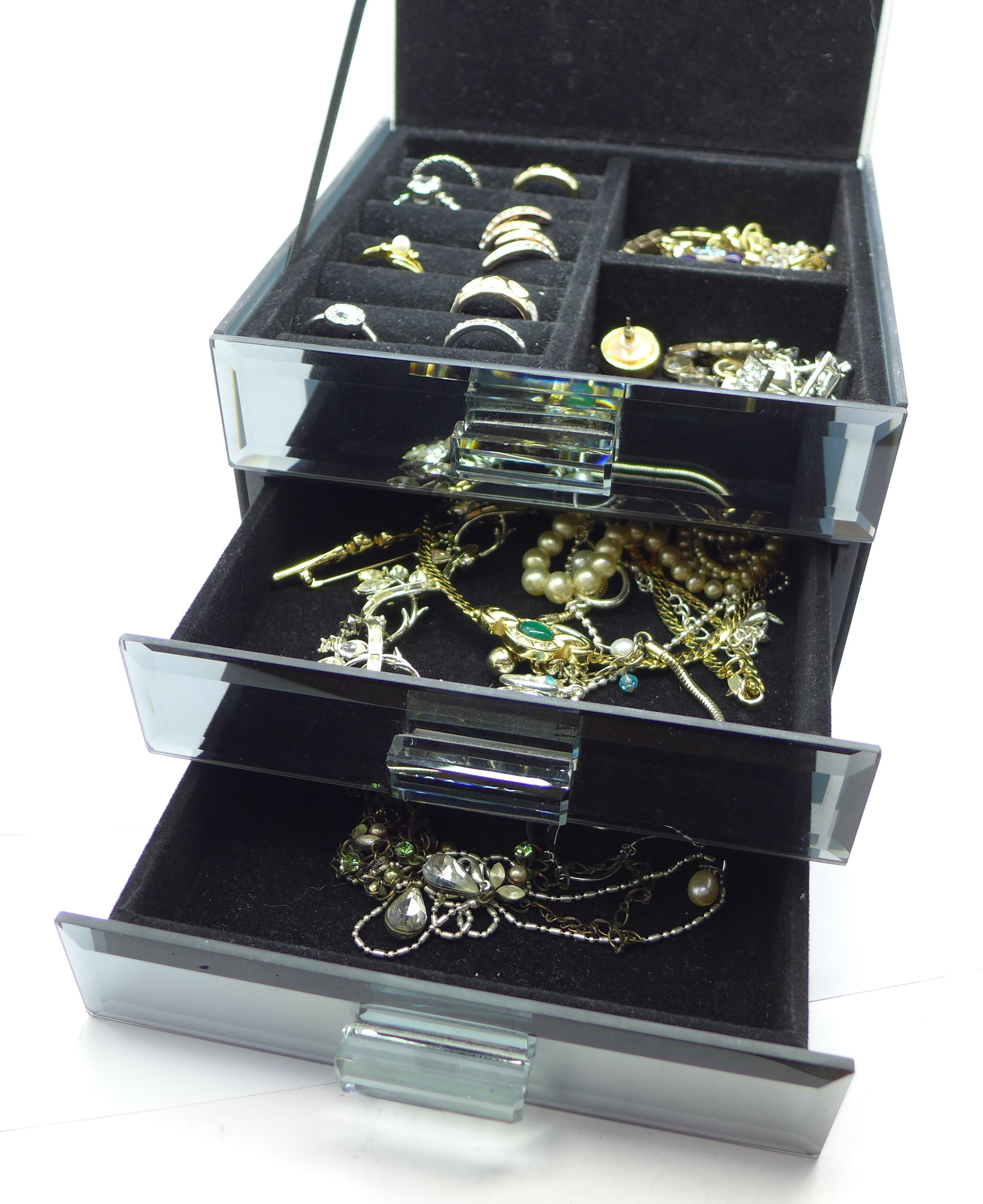 Fashion jewellery in a mirrored three drawer cabinet, 1.