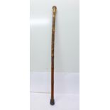 A bamboo walking stick with oriental carving
