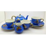 A Noritake tea for two tea set decorated with butterflies, (one small side plate),