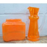 An orange glass vase and jug