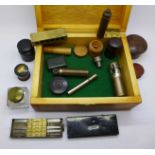 A box of assorted items including a horn thimble box, brass bullet mould, cheroot holder,