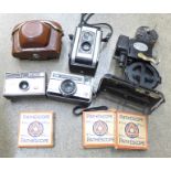 A box of cameras including Kodak Duaflex II, a Pathescope Kid film projector and three Pathescope 9.