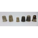 A Charles Horner silver thimble, four other silver thimbles, two a/f, and a 'cutaway' thimble,