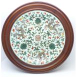 A Chinese Celadon plate in a wooden frame, Da Qianlong Nian Zhi mark,