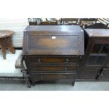 A carved oak bureau