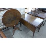 A George III oak circular tilt top tripod table and a Victorian mahogany Pembroke table