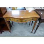 A mahogany serpentine two drawer side table