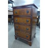 A small inlaid mahogany chest of drawers