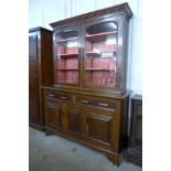 A Victorian mahogany bookcase on walnut cupboard base